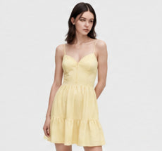 Model wearing a lemon yellow tiered sundress