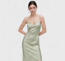 Sage green satin-effect slip dress on a model