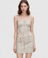 Champagne textured mini dress with broad straps on a model