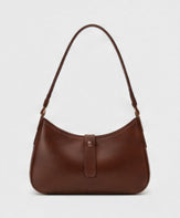 Chocolate brown crescent shoulder bag on a light gray studio background