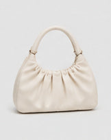 Ivory ruched handbag with a rounded top handle