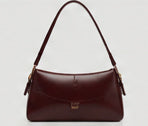 Burgundy mini shoulder bag with a curved flap
